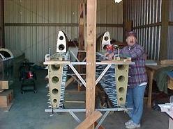 Me with my wings in North Carolina. Note the first of two fuselage jigs I made behind me, and my buddy's RV-8 in progress on the left.